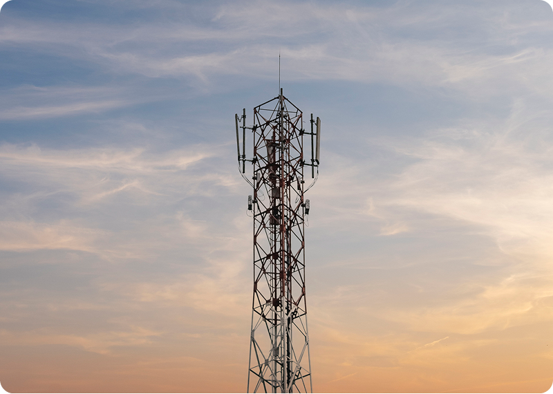 Cell tower against a sunset sky